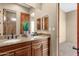 Double vanity bathroom with granite countertop and wood cabinets at 127 E Sabrosa Dr, New River, AZ 85087