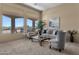 Living room with large windows, plush carpet, and comfortable seating at 127 E Sabrosa Dr, New River, AZ 85087