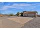 Two-car garage and paved driveway with desert landscaping at 127 E Sabrosa Dr, New River, AZ 85087