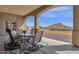 Covered patio with mountain views and outdoor dining set at 127 E Sabrosa Dr, New River, AZ 85087