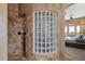 Spa-like shower with glass block feature wall and neutral tile at 127 E Sabrosa Dr, New River, AZ 85087