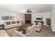 Inviting living room with a brick fireplace, wood floors, and ample natural light at 6233 W Mescal St, Glendale, AZ 85304