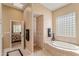 Large bathroom with tub, shower, and view to bedroom at 26601 N Aguila Rd, Rio Verde, AZ 85263