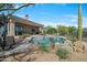 Inviting pool with patio furniture and desert landscaping at 26601 N Aguila Rd, Rio Verde, AZ 85263