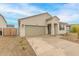 One-story home with a two-car garage and landscaped yard at 17860 W Villa Hermosa Ln, Surprise, AZ 85387