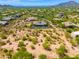 Aerial view of a luxury home with a pool and desert landscape at 8563 E Tumbleweed Dr, Scottsdale, AZ 85266