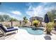 Inviting kidney shaped pool with a waterfall feature and lounge chairs at 3629 W Amerigo Ct, Anthem, AZ 85086