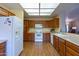 Bright kitchen with wood cabinets, laminate flooring, and modern appliances at 8217 E Natal Ave, Mesa, AZ 85209