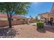 Landscaped backyard with gravel and a covered patio at 8217 E Natal Ave, Mesa, AZ 85209