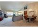 Open living and dining area with vaulted ceilings and carpet flooring at 8217 E Natal Ave, Mesa, AZ 85209