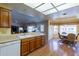 Kitchen features wood cabinets, laminate flooring, and a breakfast nook at 8217 E Natal Ave, Mesa, AZ 85209