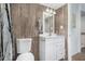 Bathroom with a toilet, sink, and wood-look tile at 6565 N 19Th Ave # 21, Phoenix, AZ 85015