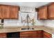 Kitchen sink and countertop with wood cabinets at 6565 N 19Th Ave # 21, Phoenix, AZ 85015