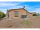 Rear exterior view of the house with gravel and AC unit at 437 E Germann Rd # 146, San Tan Valley, AZ 85140