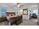 Main bedroom with wood bed frame and ensuite at 437 E Germann Rd # 146, San Tan Valley, AZ 85140