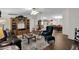 Living room with leather sofa, wood flooring, and view into dining area at 437 E Germann Rd # 146, San Tan Valley, AZ 85140
