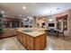 Open kitchen with large island, breakfast bar, and granite countertops at 6338 E Amber Sun Dr, Scottsdale, AZ 85266