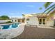 Freeform pool with travertine decking and access from the home at 8513 E Belgian Trl, Scottsdale, AZ 85258