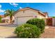 Landscaped front yard with flowering bushes and a decorative gate at 1451 E Palm Beach Dr, Chandler, AZ 85249
