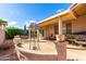 Outdoor patio area with seating, windmill decor, and covered patio at 1451 E Palm Beach Dr, Chandler, AZ 85249