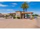 Gated entrance to a community with guardhouse, palm trees, and ample parking at 1451 E Palm Beach Dr, Chandler, AZ 85249