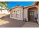 Front entry with brick pavers, a wooden door, and a potted plant at 1451 E Palm Beach Dr, Chandler, AZ 85249