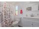 Bathroom with shower/tub, white vanity, and floral shower curtain at 9693 E Frito Ave, Mesa, AZ 85208