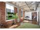 Bedroom with large TV and exposed brick walls at 114 W Adams St # 808, Phoenix, AZ 85003