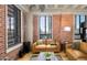 Tan leather couch in living room with exposed brick walls at 114 W Adams St # 808, Phoenix, AZ 85003