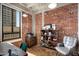 Home office with built-in shelving and brick wall at 114 W Adams St # 808, Phoenix, AZ 85003