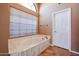 Relaxing bathroom with soaking tub and separate shower at 13302 W Serenade Cir, Sun City West, AZ 85375