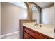 Elegant bathroom with marble vanity and arched mirror at 13302 W Serenade Cir, Sun City West, AZ 85375