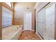 Bathroom with a large bathtub, a separate shower, and tiled floors at 13302 W Serenade Cir, Sun City West, AZ 85375