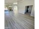 Spacious living room with wood-look floors and a view into other rooms at 20411 N 99Th Dr, Peoria, AZ 85382