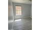 Bright bedroom with wood-look flooring and a window at 20411 N 99Th Dr, Peoria, AZ 85382