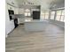 Modern kitchen with white cabinets, granite island, and gray vinyl flooring at 20411 N 99Th Dr, Peoria, AZ 85382