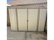 Beige metal storage shed in backyard at 20411 N 99Th Dr, Peoria, AZ 85382