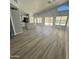 Spacious living room with high ceilings, lots of natural light, and wood-look flooring at 20411 N 99Th Dr, Peoria, AZ 85382