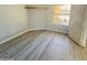 Simple bedroom with wood-look floors and a window at 20411 N 99Th Dr, Peoria, AZ 85382