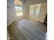 Bright bedroom with wood-look floors and a window overlooking the backyard at 20411 N 99Th Dr, Peoria, AZ 85382