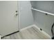 Bright laundry room with built-in shelving and vinyl flooring at 20411 N 99Th Dr, Peoria, AZ 85382