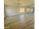 Spacious living room with light walls, wood-look flooring, and a large window at 20411 N 99Th Dr, Peoria, AZ 85382