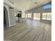 Bright and airy living room with vaulted ceilings, lots of natural light, and wood-look flooring at 20411 N 99Th Dr, Peoria, AZ 85382