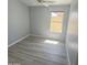 Well-lit bedroom with wood-look flooring and ceiling fan at 20411 N 99Th Dr, Peoria, AZ 85382