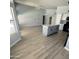 Open concept kitchen and dining area with modern finishes and wood-look flooring at 20411 N 99Th Dr, Peoria, AZ 85382