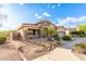 House exterior, tan colored with stone accents and a two car garage at 34218 N 26Th Ave, Phoenix, AZ 85085