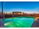 Clear blue pool at dusk, with a home and fence in the background at 9645 E Brown Rd, Mesa, AZ 85207