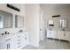 Contemporary double vanity bathroom with white cabinets and marble countertops at 2122 W Virginia Ave, Phoenix, AZ 85009