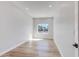 Bright bedroom with light wood flooring and a window overlooking the street at 2122 W Virginia Ave, Phoenix, AZ 85009