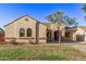 Tan house with arched windows and driveway at 21574 E Bonanza Ct, Queen Creek, AZ 85142